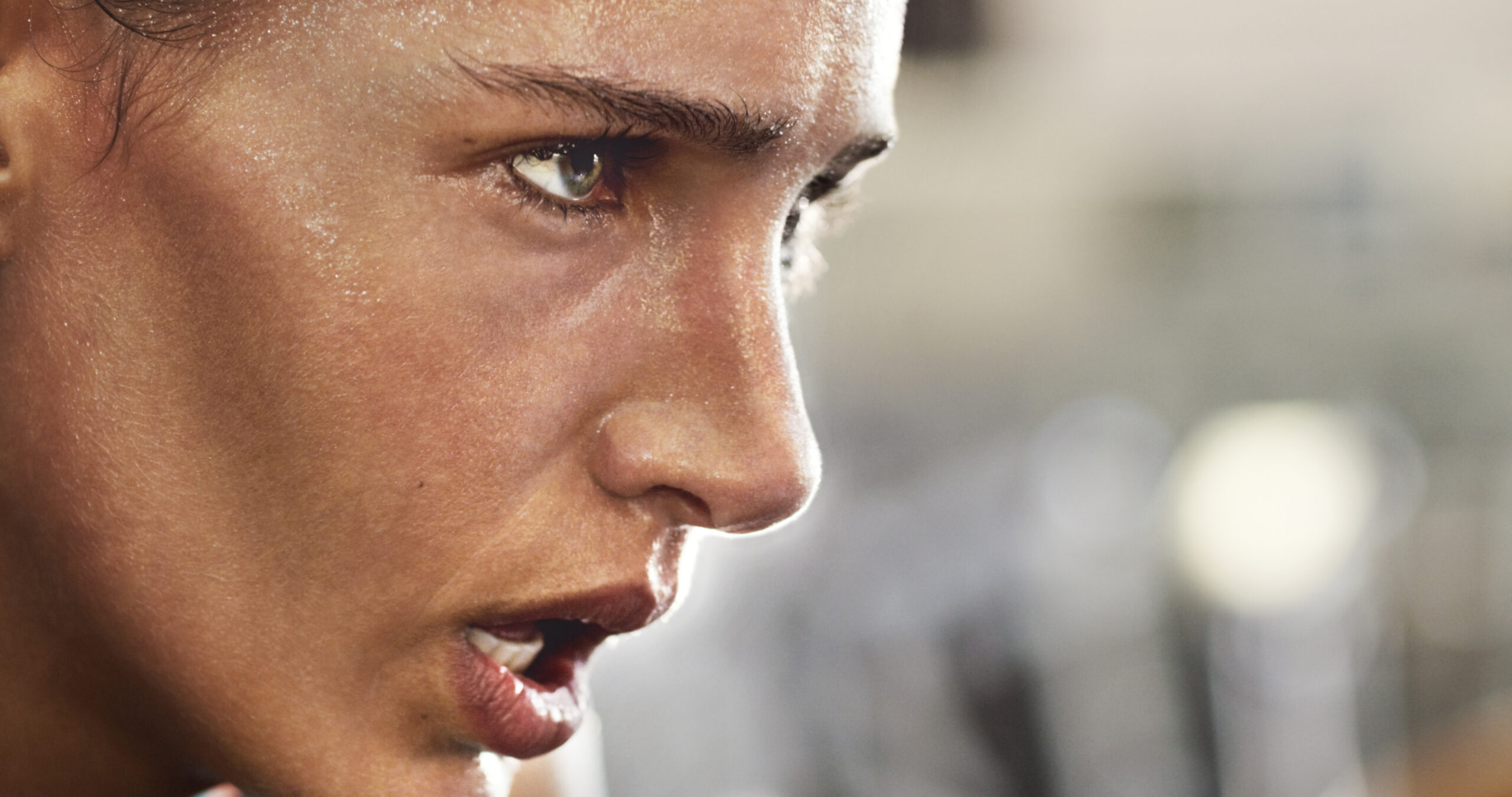 Cropped shot of a determined looking young woman working out in the gym